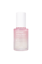 A bottle of Anti-Mela Toing Serum with a pink label and clear liquid visible inside.