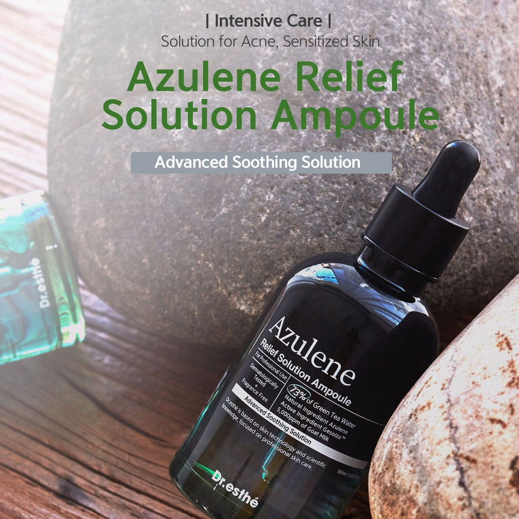 Azulene Relief Solution Ampoule bottle with dropper on a wooden surface with stones in the background