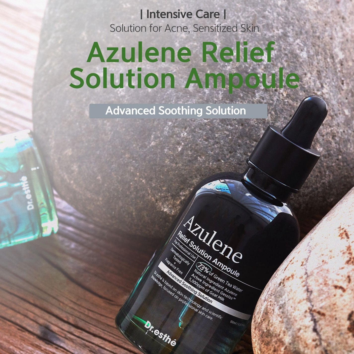 Azulene Relief Solution Ampoule bottle with dropper on a wooden surface with stones in the background
