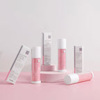 Cosmetic products with pink and white packaging on a light pink background