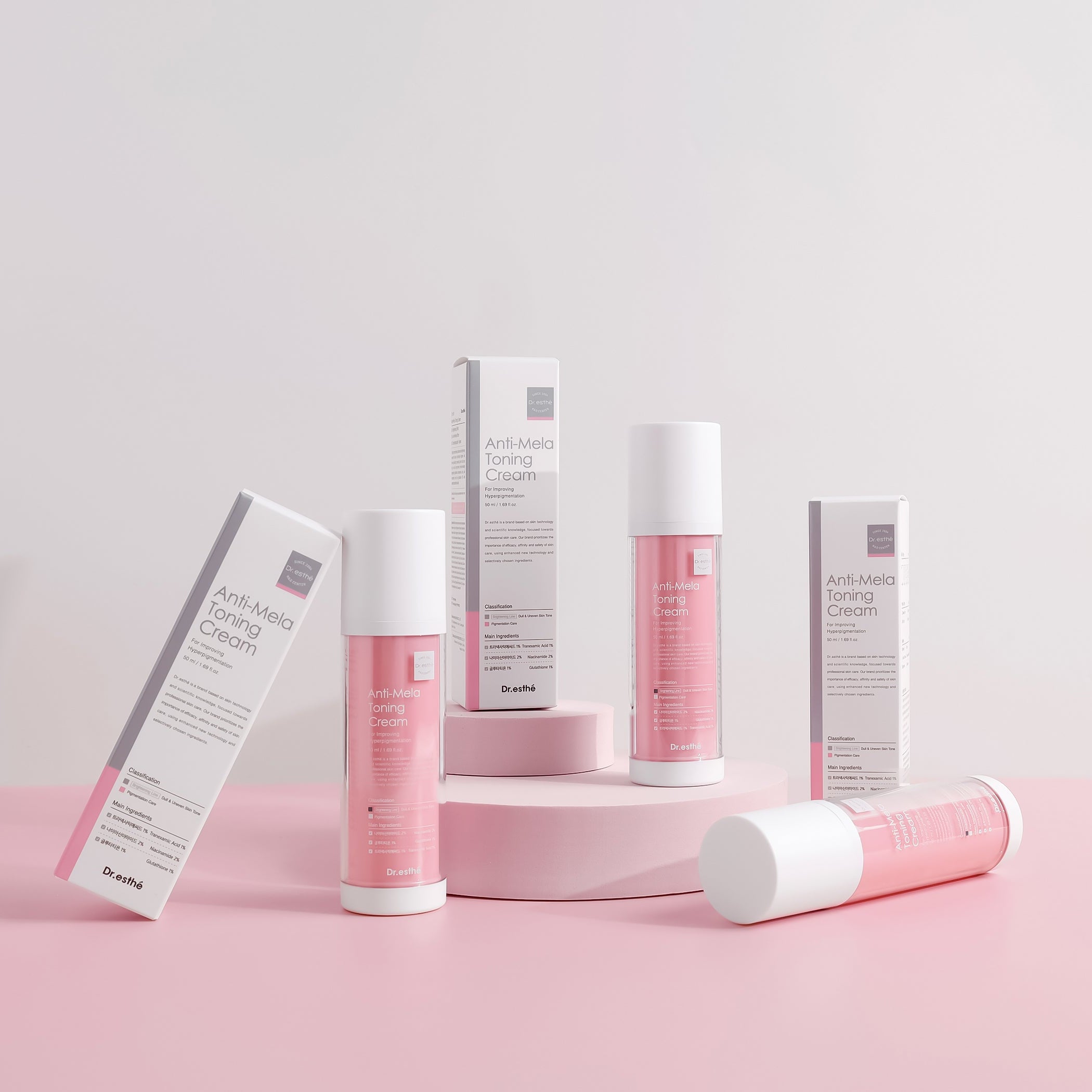 Cosmetic products with pink and white packaging on a light pink background