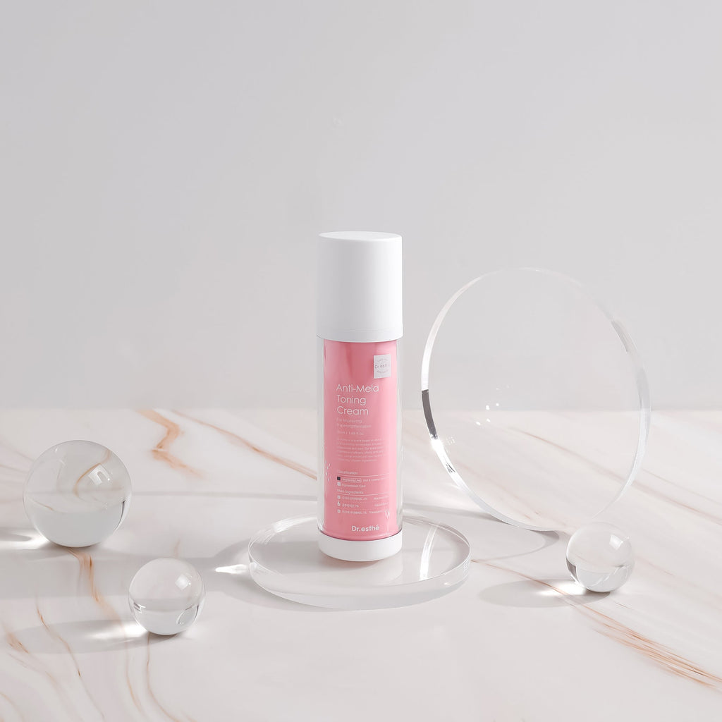 Skincare bottle with pink label on a marble surface
