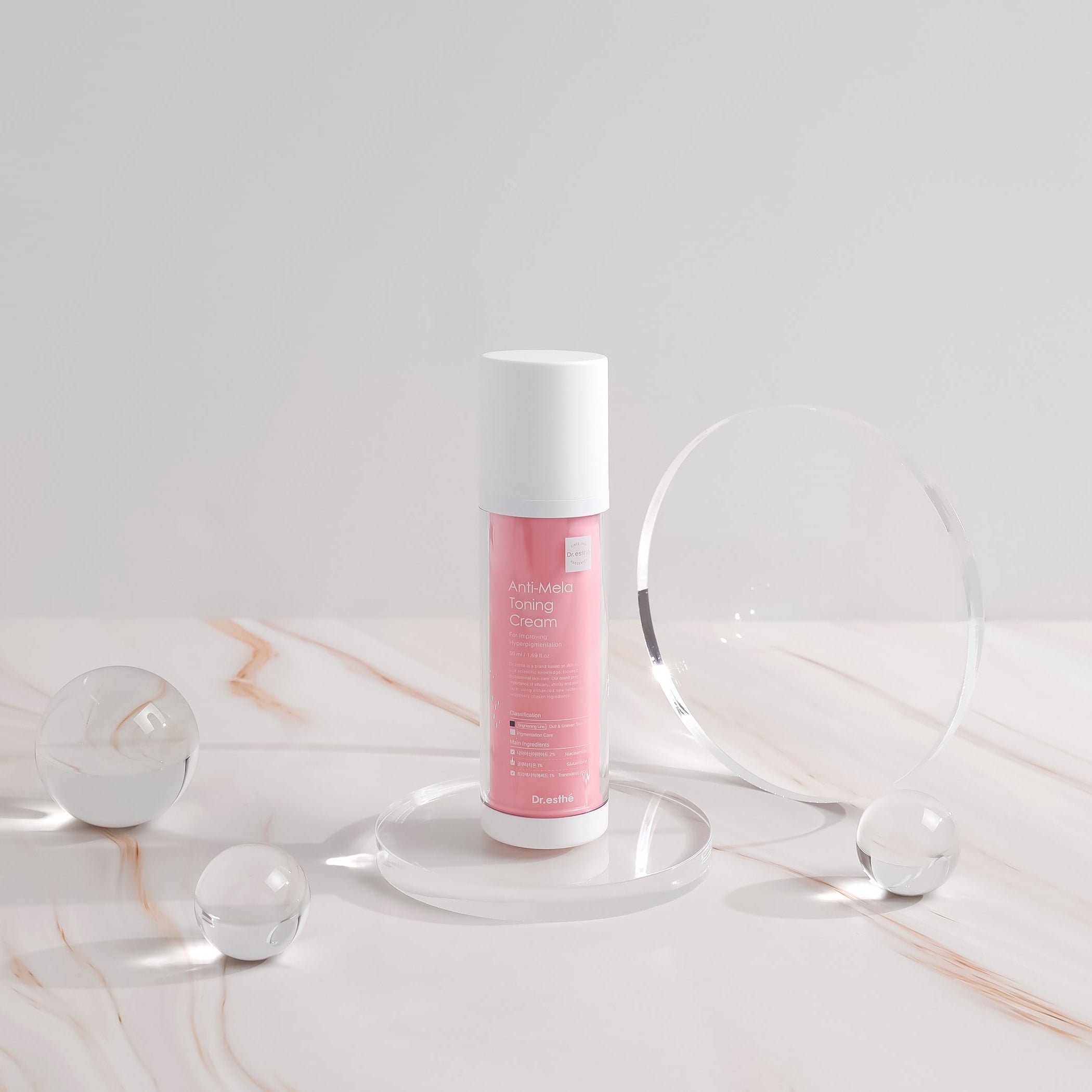 Skincare bottle with pink label on a marble surface
