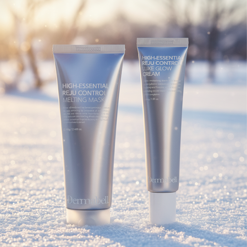 Two Dermabell High Essential Reju Control skincare products, peel off collagen mask and luxe glow cream, on a snowy surface with a blurred natural background