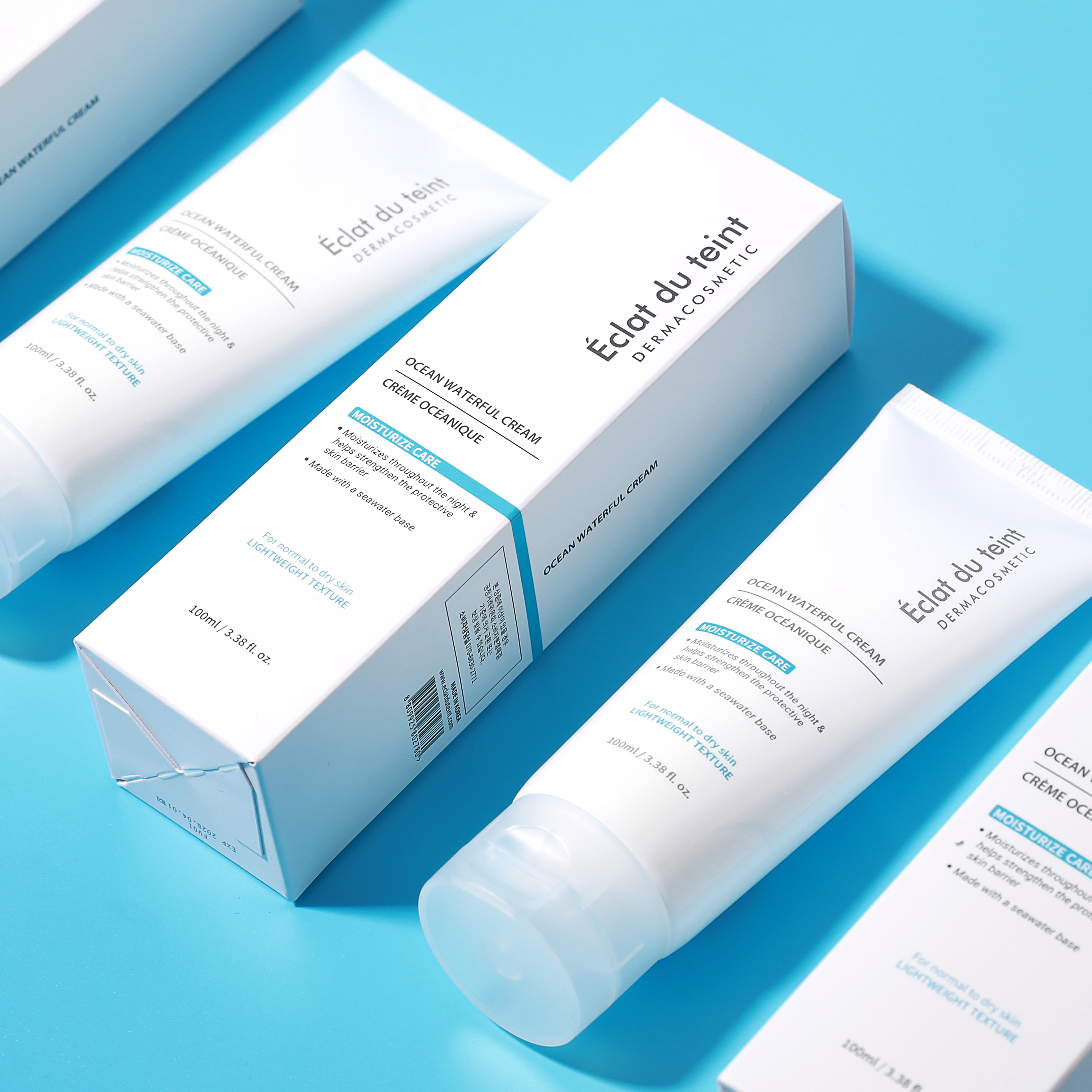 Cosmetic product and packaging labeled 'Eclat du teint Ocean Waterful Cream' moisturizer  on a blue background