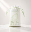 A white drawstring pouch of stretchable facial gauze with green text and a large pale green gauze illustration on the front, photographed on a clean white background.