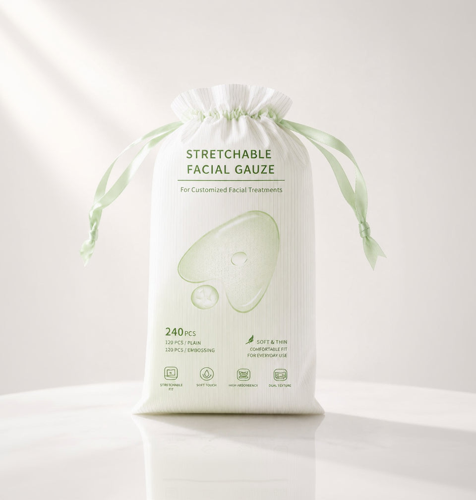 A white drawstring pouch of stretchable facial gauze with green text and a large pale green gauze illustration on the front, photographed on a clean white background.