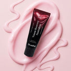 A tube of Dr. Esthe Venom Recovery Neutralizer resting on a glossy swirl of pink cream against a solid pink background.